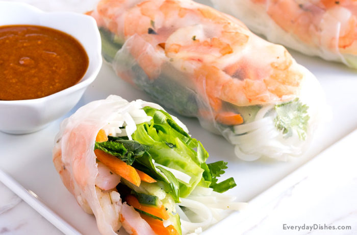 A plate of some delicious fresh shrimp summer rolls.