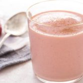 A glass full of a delicious strawberry oatmeal smoothie