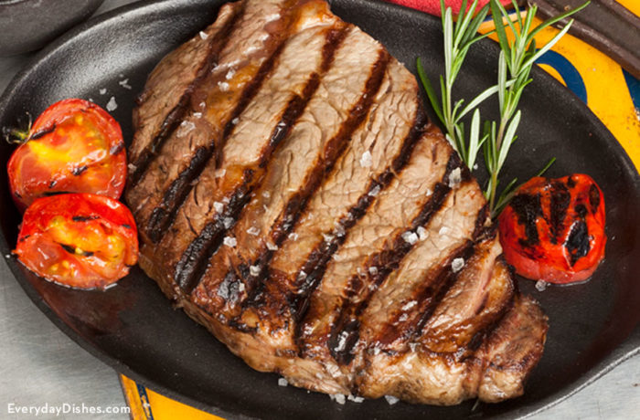Marinated grilled steak, on a plate and ready to enjoy for dinner.
