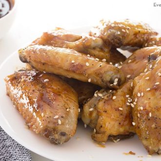 A plate with a serving of honey teriyaki chicken wings.