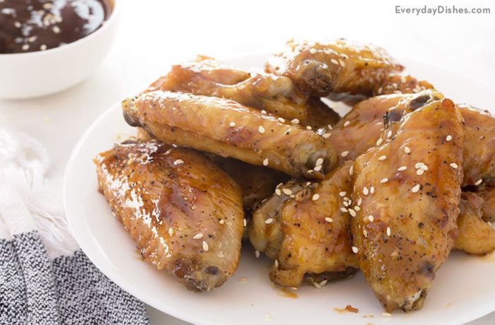 A plate with a serving of honey teriyaki chicken wings.