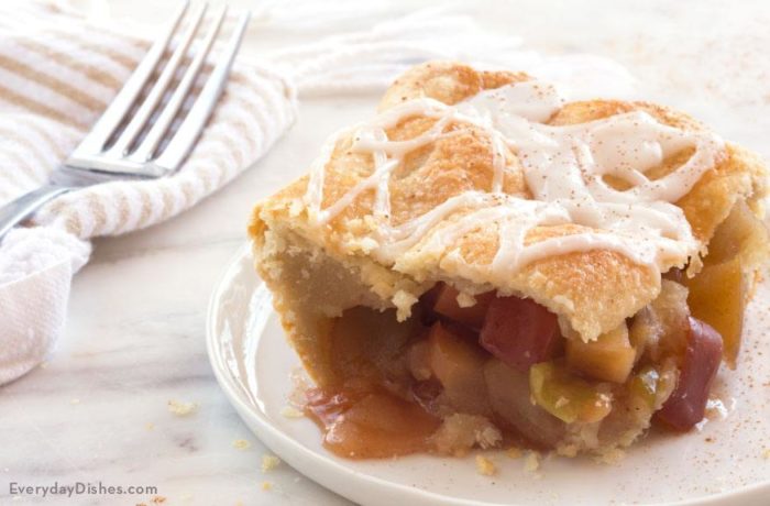 A slice of apple slab pie, on a plate and ready to enjoy.