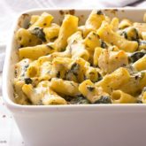 A dish full of chicken and spinach pasta bake that's ready to serve for dinner.