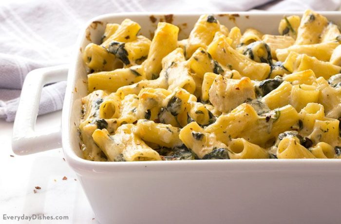 A dish full of chicken and spinach pasta bake that's ready to serve for dinner.