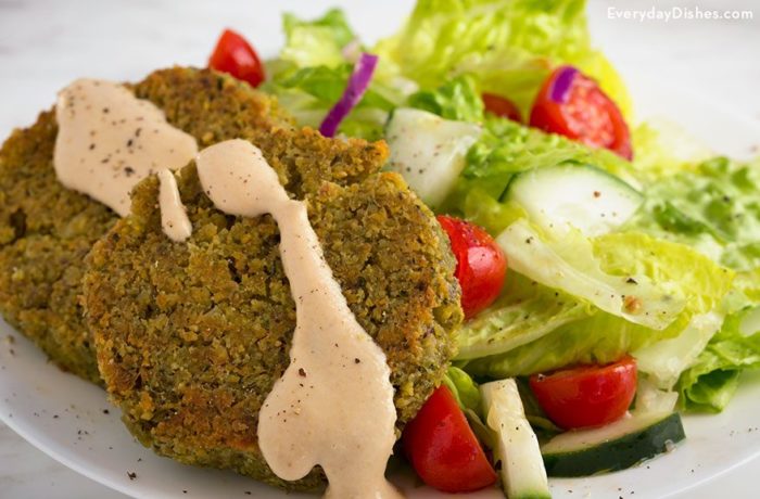 A plate with a serving of homemade baked falafel with a side salad, a great dinner.