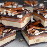 A batch of homemade Snickers bars that are ready to enjoy.