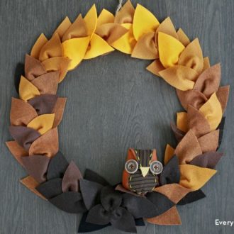 A DIY felt leaf wreath with an owl perched on it — an adorable autumn craft.
