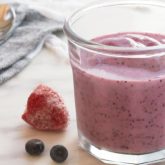 A glass full of a healthy berry smoothie