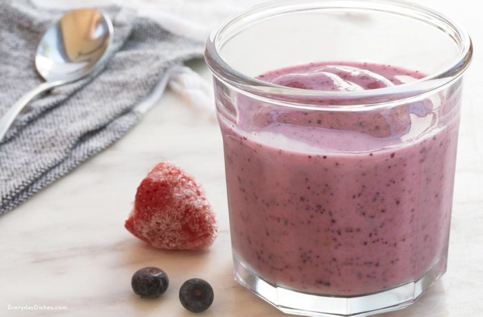 A glass full of a healthy berry smoothie