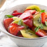 A bowl of kiwi strawberry basil salad, ready to enjoy.