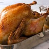 A turkey that was roasted perfectly in a baking dish.