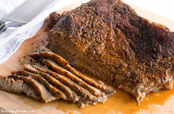 Oven-roasted red meat brisket that is sliced and prepared for dinner.  Easy Oven-Roasted Pork Brisket beef brisket everydaydishes com H 700x460