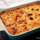 A dish of cheesy scalloped potatoes, the perfect side dish for dinner.