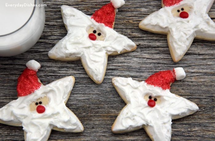 Some star-shaped cookies that are decorated to look like Santa