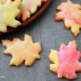 Glazed leaf-shaped sugar cookies, a delicious fall treat.