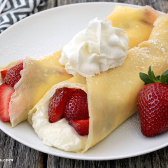 Two fast, easy, and delicious strawberry crepes, topped with whipped cream — the best breakfast.