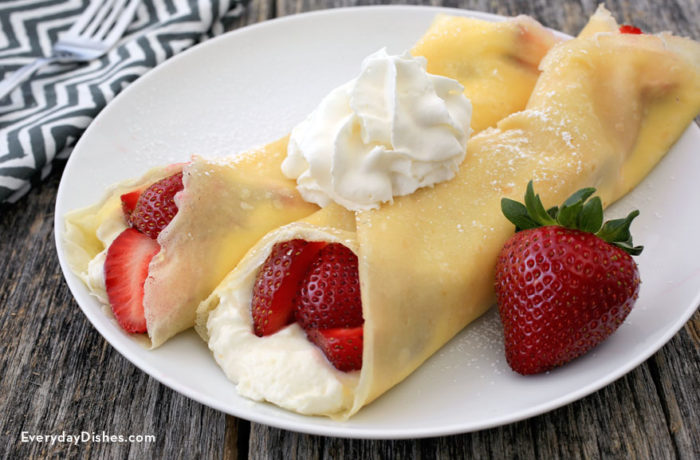 Two fast, easy, and delicious strawberry crepes, topped with whipped cream — the best breakfast.
