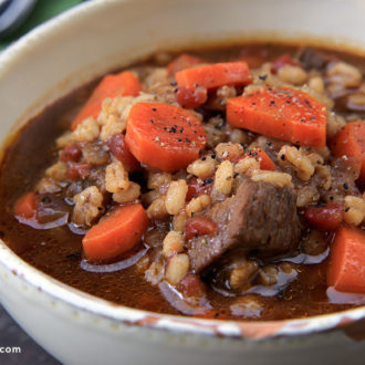 A delicious bowl of beef, barley, and vegetable soup.