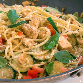 A skillet full of light chicken linguine that's ready to serve for dinner.