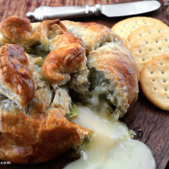 An ooey gooey pesto baked brie, a delicious appetizer.