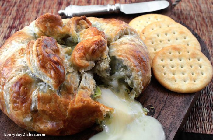 An ooey gooey pesto baked brie, a delicious appetizer.