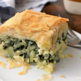 A serving of potato spinach pie that's perfect for a vegetarian dinner.