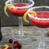 Two glasses of a refreshing raspberry champagne punch cocktail.