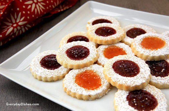 Cream cheese thumbprint cookies with jam that are on a plate and ready to enjoy.