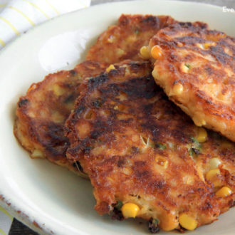 A plate of delicious cheesy corn cakes, great for an appetizer or side dish.