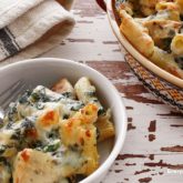 A serving of hearty asiago chicken pasta bake — a dinner that can feed the whole family!