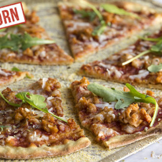 A homemade einkorn chicken sausage pizza with arugula