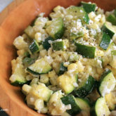 A bowl of light and creamy corn and zucchini, a vegetarian side dish.
