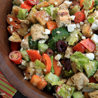 A bowl of Greek chicken Panzanella salad, ready to serve.