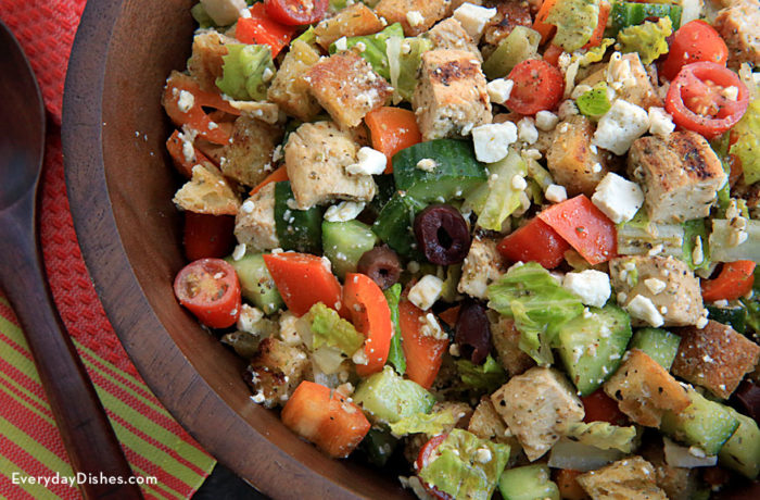 A bowl of Greek chicken Panzanella salad, ready to serve.