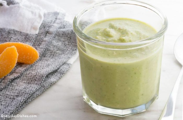 A glass full of a delicious green ginger peach smoothie
