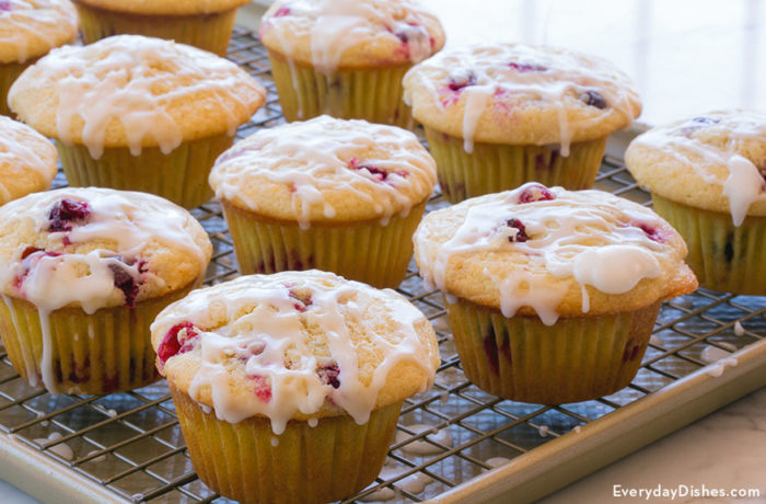 Freshly baked lemon cranberry muffins on a cooling rack, ready to enjoy.