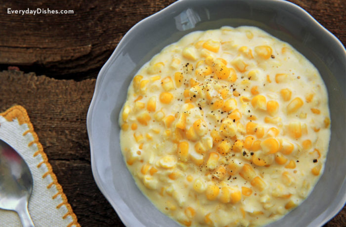 A dish full of a slow cooker creamed corn — the perfect side dish.