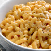 A bowl of homemade stovetop mac-n-cheese, a creamy and delicious lunch or dinner.
