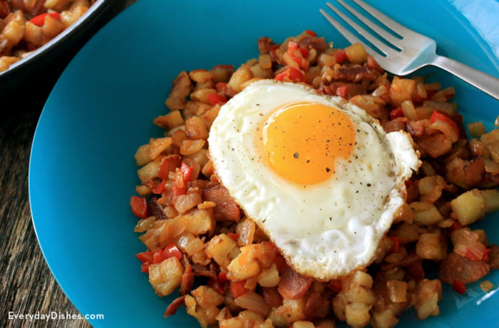 A plate of delicious breakfast hash, topped with an egg. The perfect way to start the day.