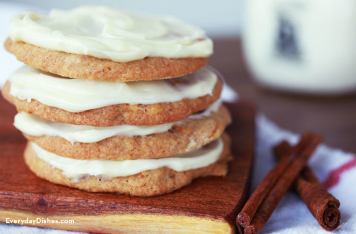 Several delicious chewy carrot cake cookies stacked on top of each other.