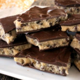 A batch of homemade cookie dough bark that's broken into pieces to serve for dessert or as a snack.