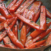 A skillet full of glazed carrots with cinnamon, a delicious side dish.
