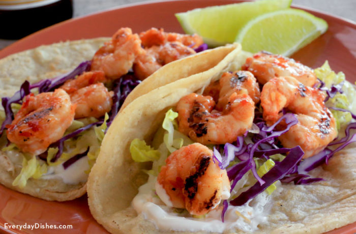 Two spicy grilled shrimp tacos, ready to enjoy.