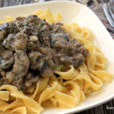 A quick hamburger stroganoff with mushrooms served on a bed of pasta.