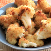 A bowl of roasted cauliflower with asiago cheese — a delicious side dish.