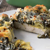 Spinach artichoke chicken, on a plate and ready for dinner.