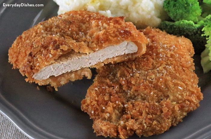 Some crunchy pork cutlets on a plate and ready to eat for dinner.
