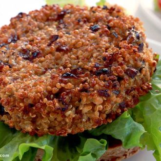 A mushroom quinoa patty, on a bun with lettuce and ready for toppings.