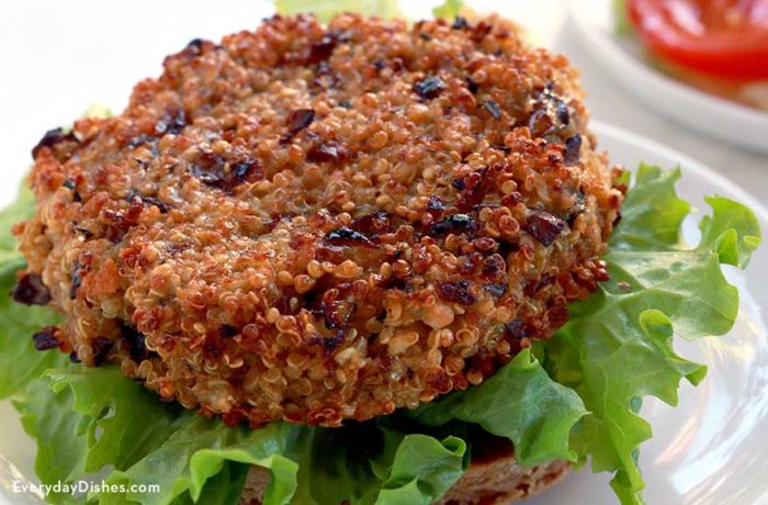 A mushroom quinoa patty, on a bun with lettuce and ready for toppings.