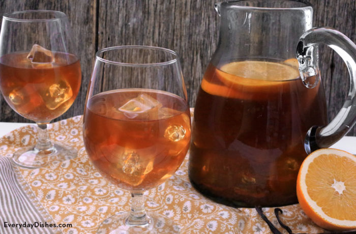A pitcher and two glasses of refreshing tea infused with orange and vanilla, perfect for the summer!